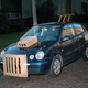 Illustration for article titled This Artist Turns Boring Rides Into Supercars At Night Using Cardboard